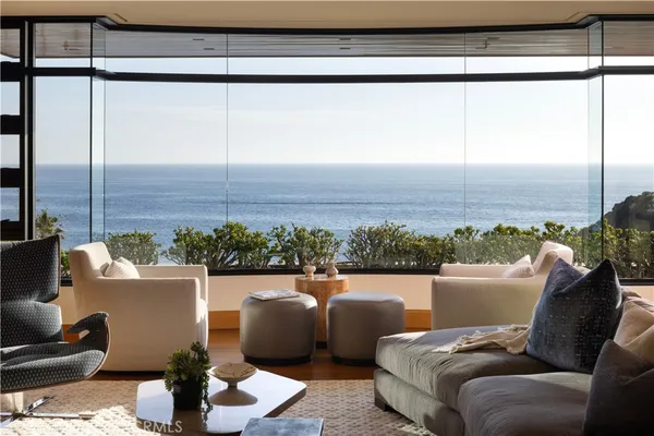 a living room with furniture and a floor to ceiling window
