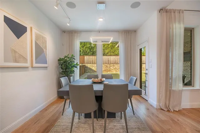 a large white kitchen with lots of counter space a sink and appliances