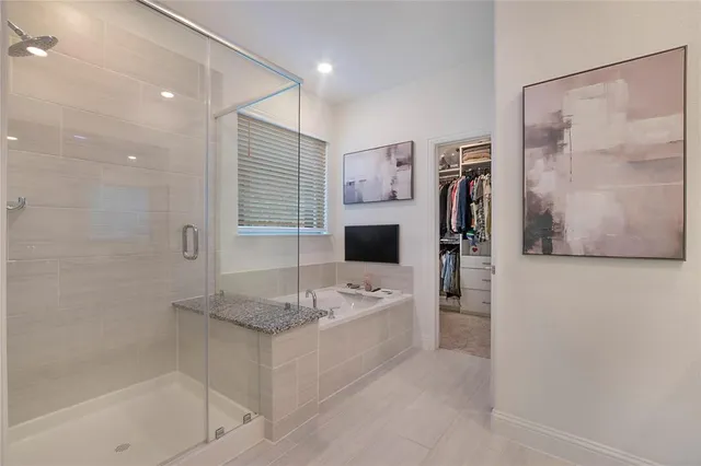 a spacious bedroom with a bed and a chandelier