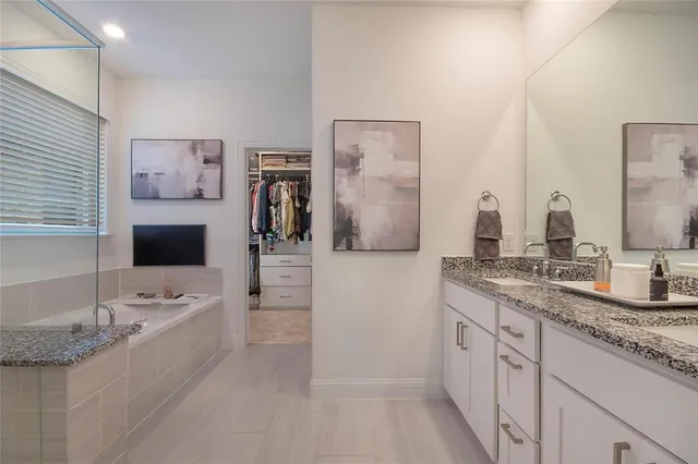 a bedroom with a bed and a ceiling fan