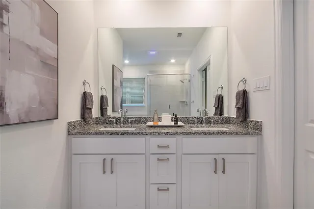 a bathroom with a tub sink and mirror