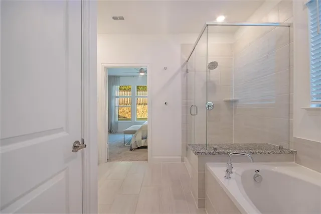 a spacious bathroom with a granite countertop sink and a mirror
