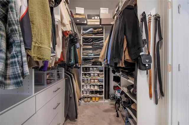 a bathroom with a tub shower sink and mirror