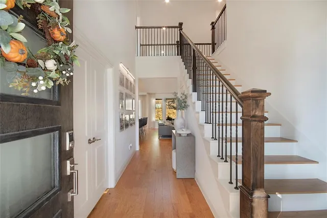 a view of entryway and hall with wooden floor