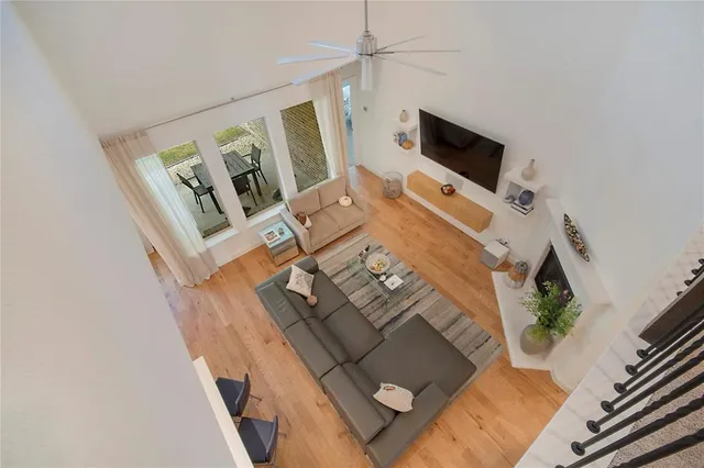 a bedroom with a bed a flat screen tv and a chandelier