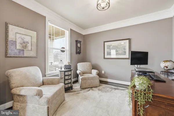 a dining room with furniture a chandelier and window