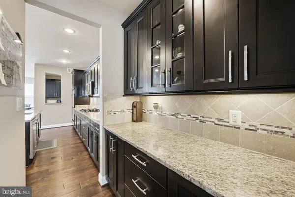 a kitchen with counter space sink appliances and cabinets
