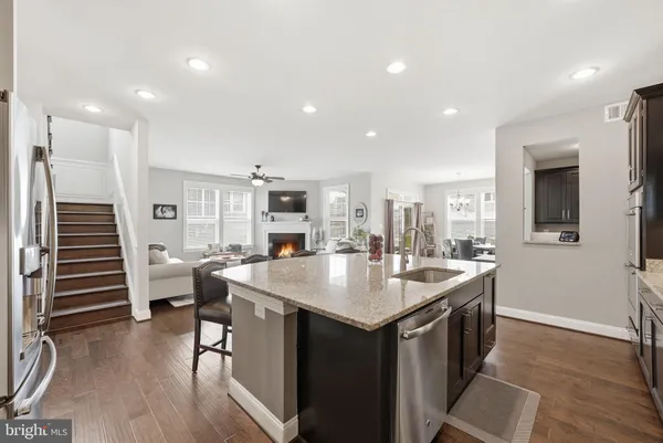 a kitchen with stainless steel appliances granite countertop a sink stove and microwave