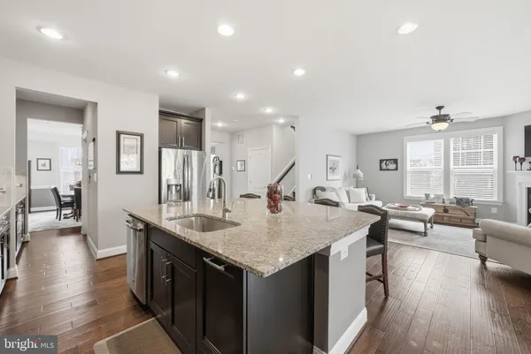 a living room with stainless steel appliances furniture and a large window