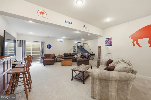a living room with furniture a flat screen tv and a couch