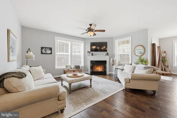 a living room with furniture flat screen tv and a fireplace