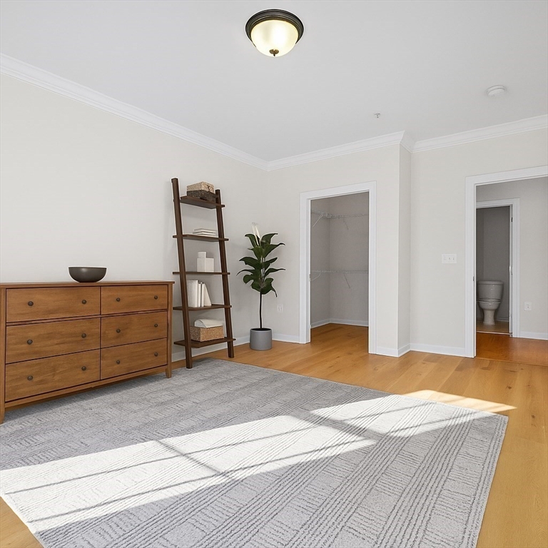 170 Clocktower Drive, Unit 5103 Waltham, MA 02452 - Photo 11 of 29 a bedroom with a bed and a dresser