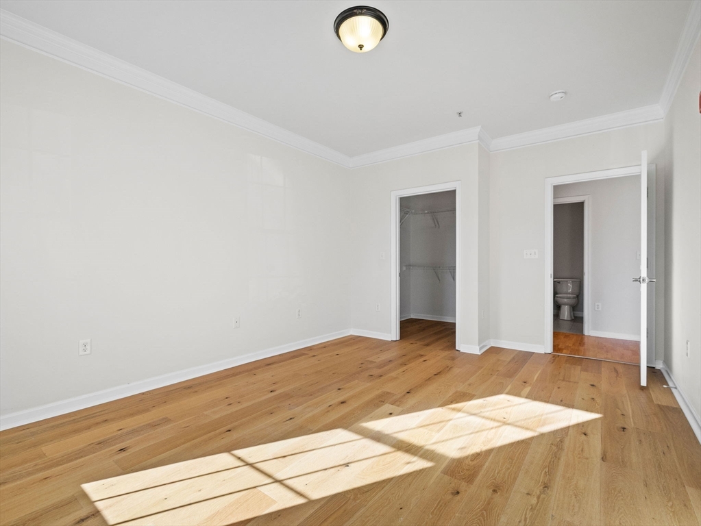 170 Clocktower Drive, Unit 5103 Waltham, MA 02452 - Photo 12 of 29 a view of empty room with wooden floor