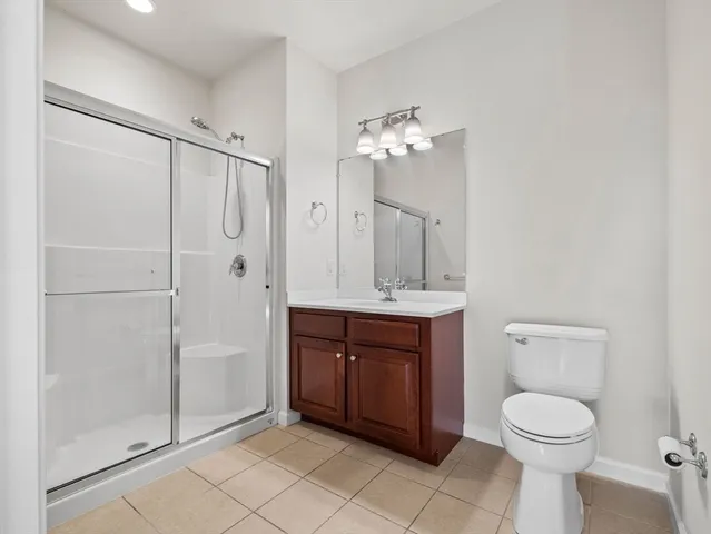 a bathroom with a toilet a sink and shower
