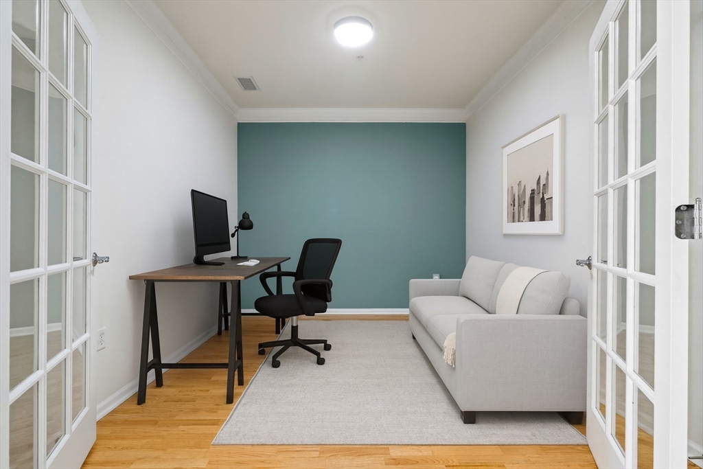 170 Clocktower Drive, Unit 5103 Waltham, MA 02452 - Photo 16 of 29 a view of a livingroom with workspace and a couch