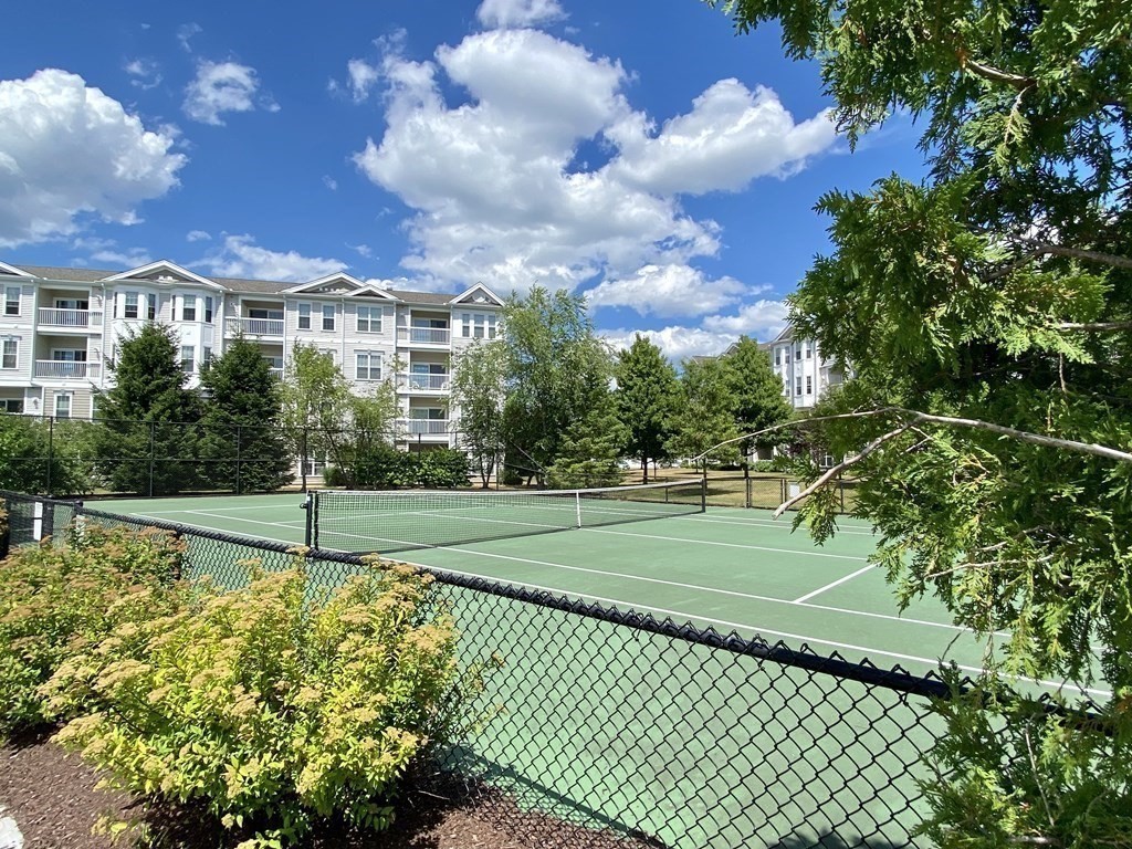 170 Clocktower Drive, Unit 5103 Waltham, MA 02452 - Photo 22 of 29 a view of a house with a big yard