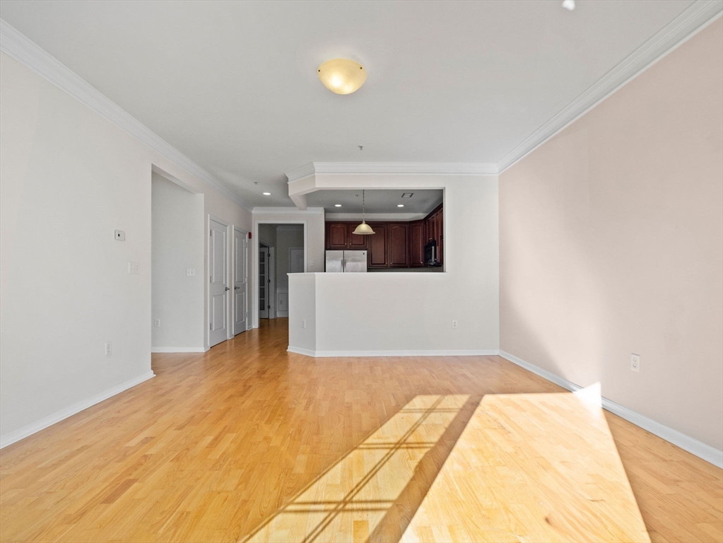 170 Clocktower Drive, Unit 5103 Waltham, MA 02452 - Photo 4 of 29 a view of a big room with wooden floor and windows