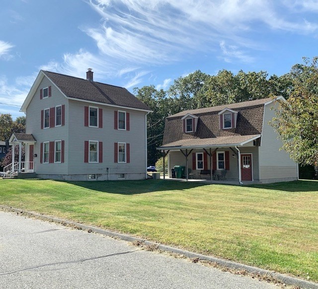 128 Ann Street Chicopee, MA 01020 - Photo 1 of 17 a view of a house with a big yard and large trees