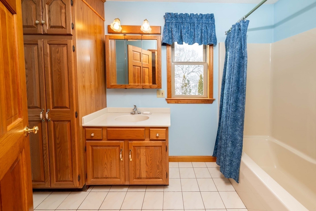 128 Ann Street Chicopee, MA 01020 - Photo 13 of 17 a bathroom with a sink a toilet and a shower