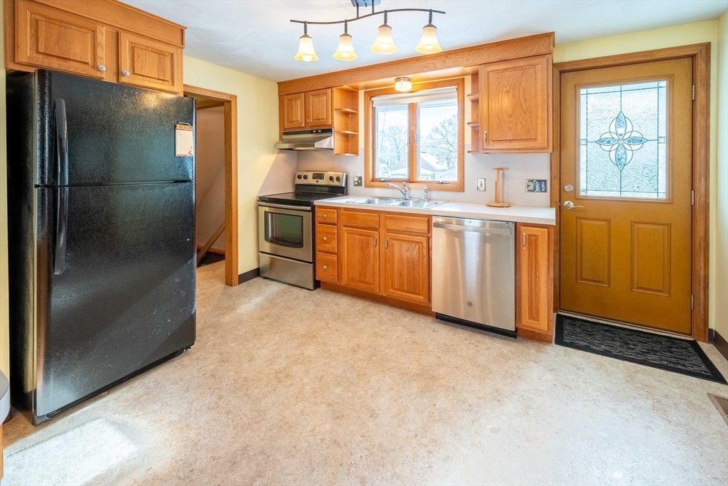 128 Ann Street Chicopee, MA 01020 - Photo 2 of 17 a kitchen with stainless steel appliances a refrigerator and a stove