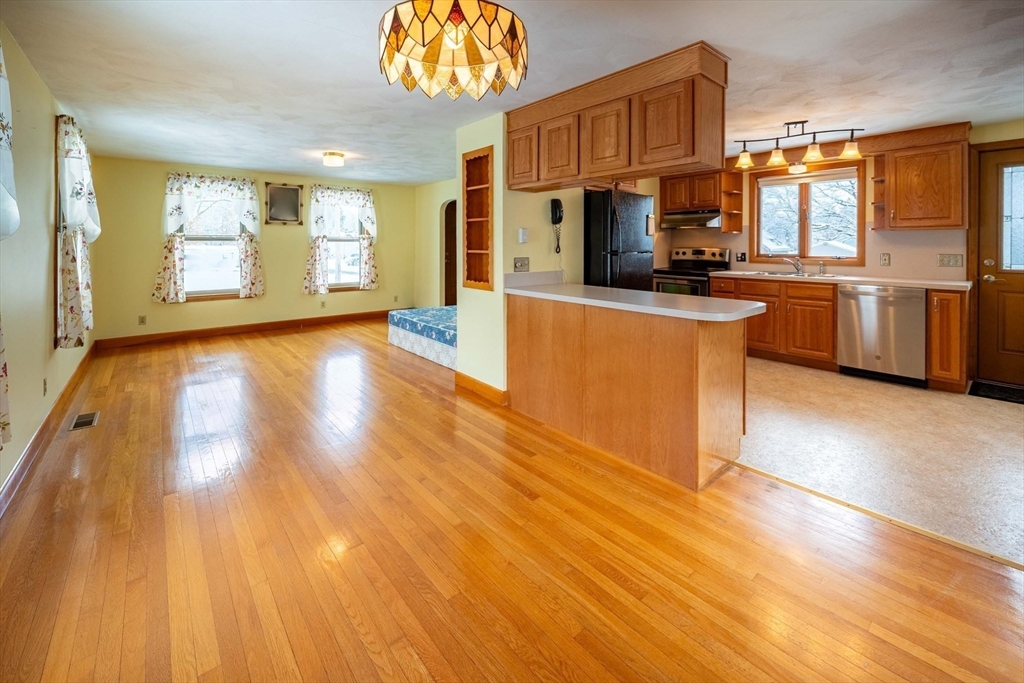 128 Ann Street Chicopee, MA 01020 - Photo 6 of 17 a kitchen with stainless steel appliances granite countertop a stove a sink and a refrigerator
