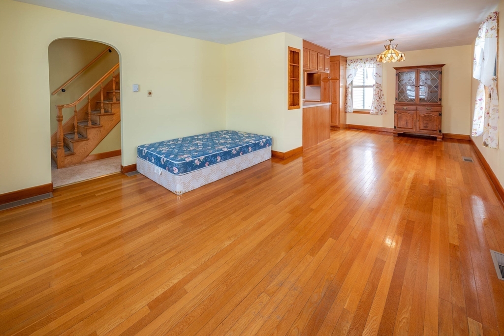 128 Ann Street Chicopee, MA 01020 - Photo 7 of 17 a living room with hard wood floors and a bed