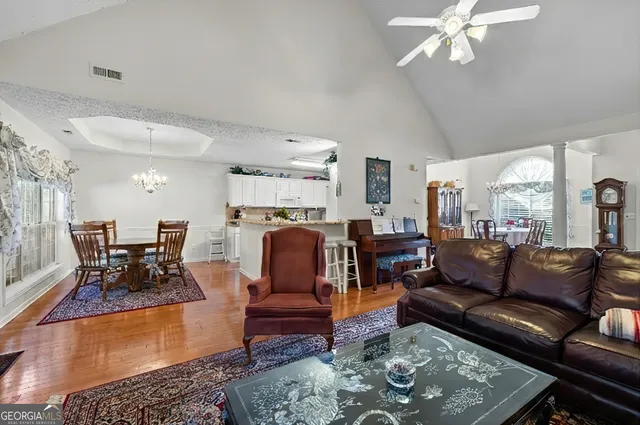 a spacious bedroom with a bed and a chandelier