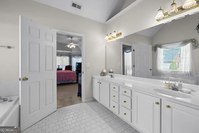 a living room with a fireplace windows and a table