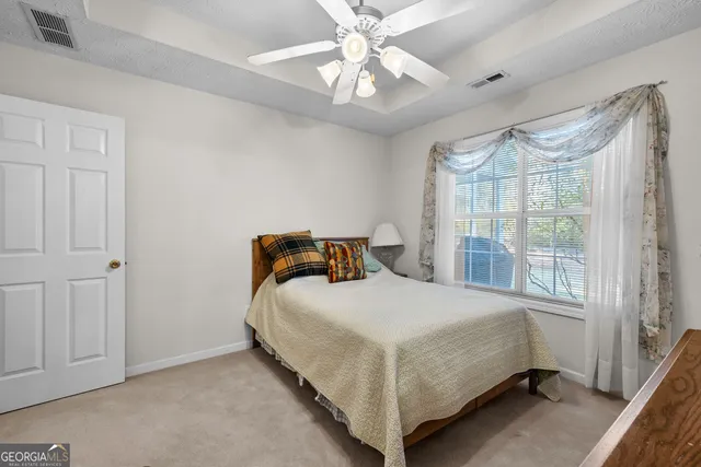 a living room with furniture and a floor to ceiling window