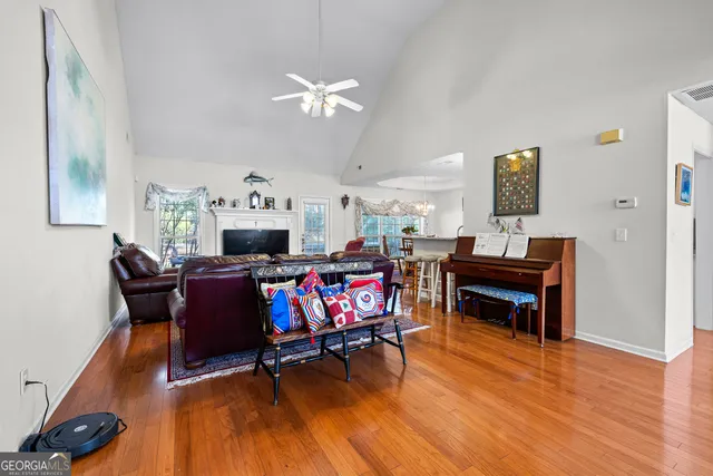 a kitchen with stainless steel appliances granite countertop a kitchen island a stove a table and chairs in it