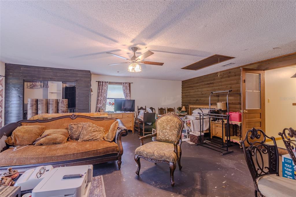 1600 Southwest 42nd Street Ocala, FL 34471 - Photo 16 of 57 a living room with furniture a flat screen tv and a large window