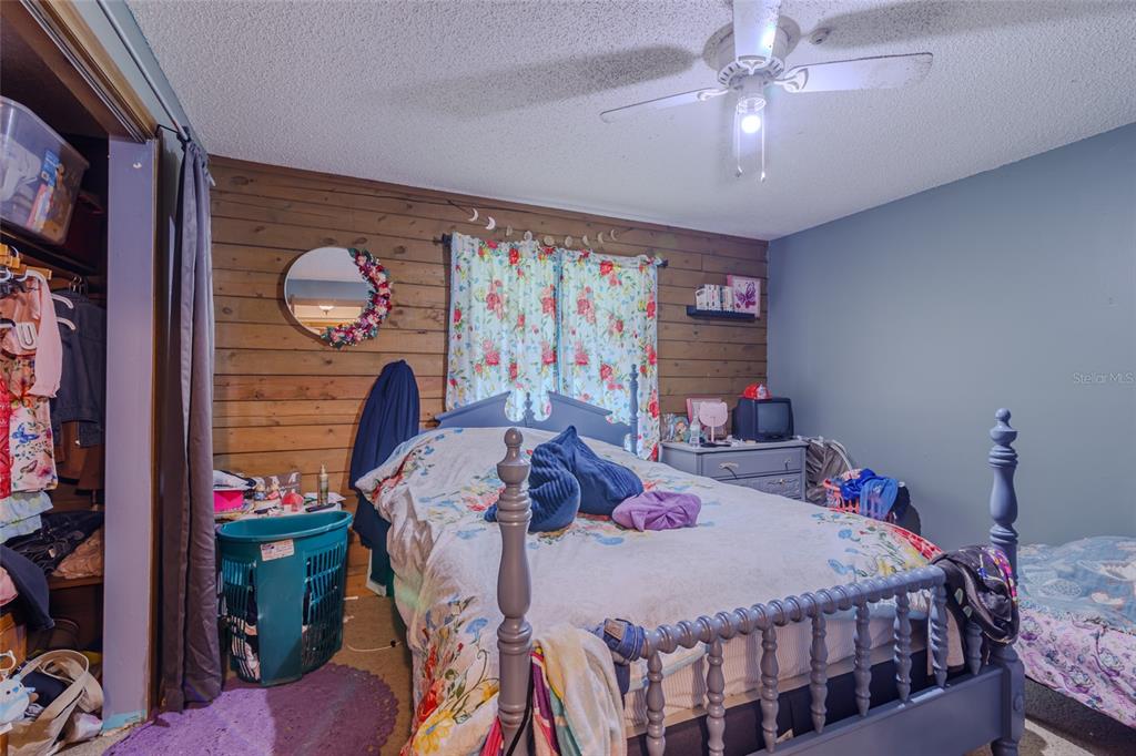 1600 Southwest 42nd Street Ocala, FL 34471 - Photo 20 of 57 a bed room with a bed and a chandelier