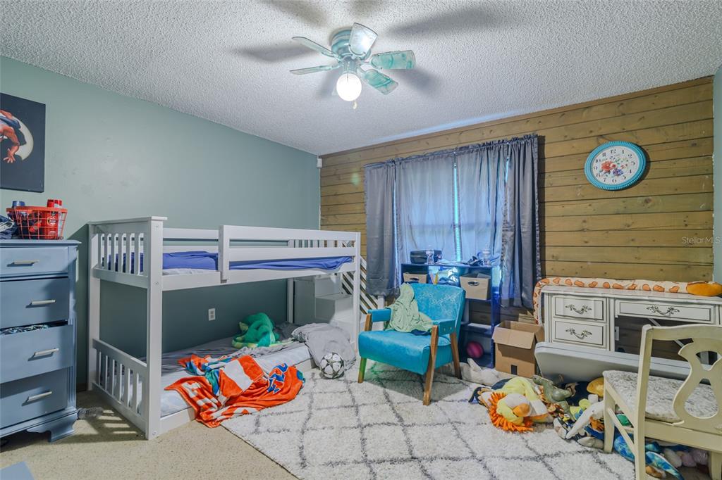 1600 Southwest 42nd Street Ocala, FL 34471 - Photo 38 of 57 a bedroom with furniture and a table