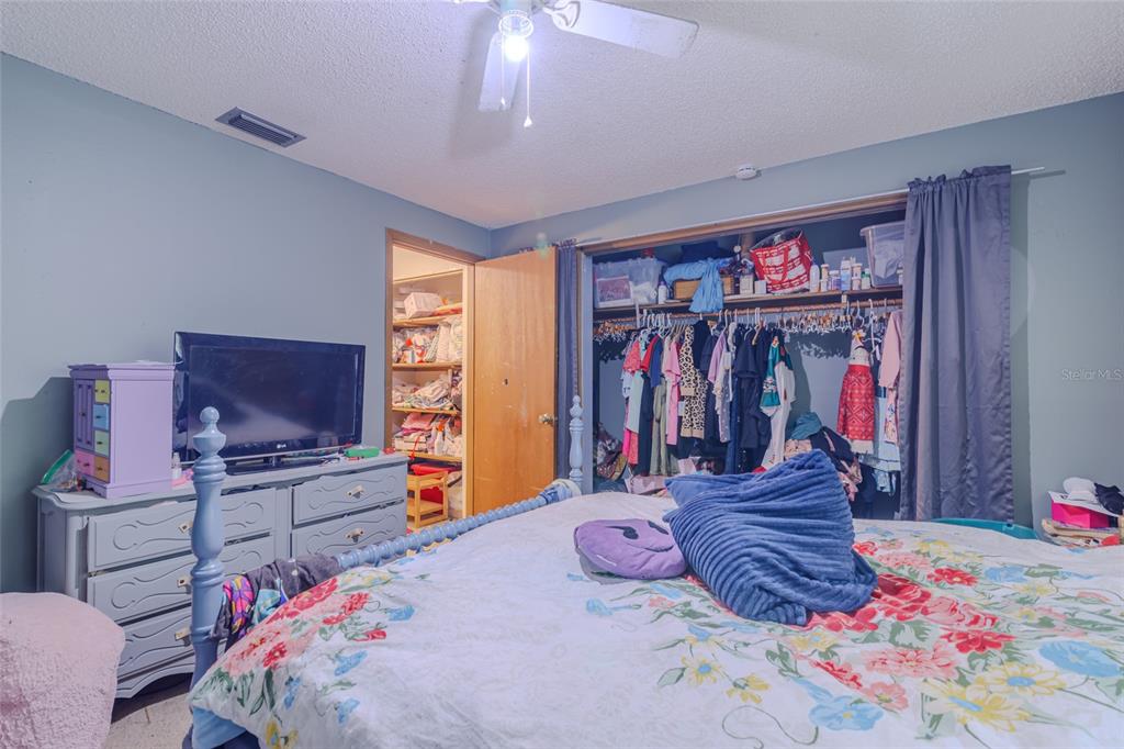 1600 Southwest 42nd Street Ocala, FL 34471 - Photo 41 of 57 a bedroom with a bed and a flat screen tv