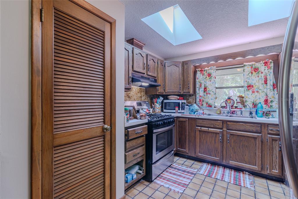 1600 Southwest 42nd Street Ocala, FL 34471 - Photo 48 of 57 a kitchen with stainless steel appliances granite countertop a sink and cabinets