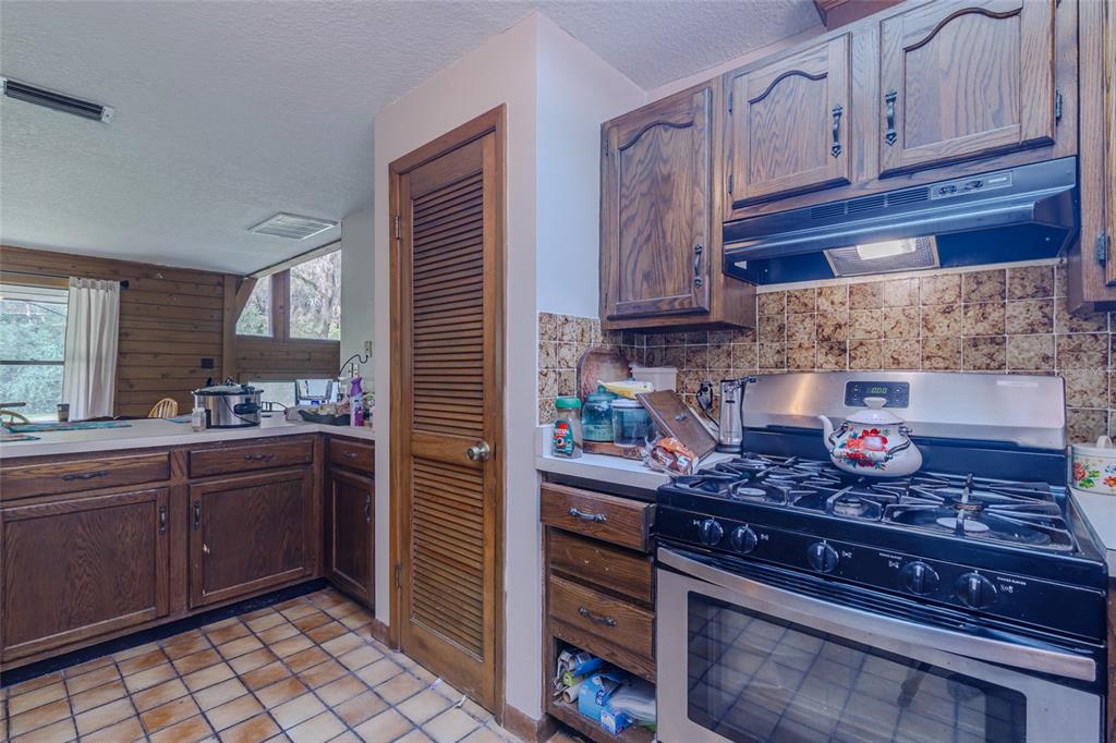 1600 Southwest 42nd Street Ocala, FL 34471 - Photo 49 of 57 a kitchen with stainless steel appliances granite countertop a stove and cabinets