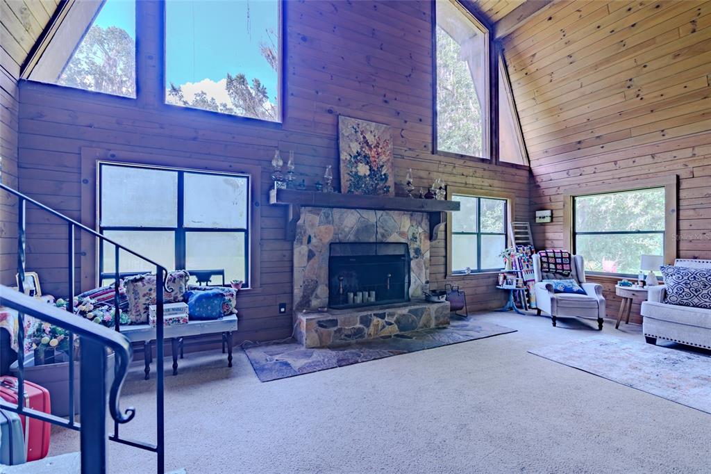 1600 Southwest 42nd Street Ocala, FL 34471 - Photo 53 of 57 a living room with furniture a fireplace and a large window