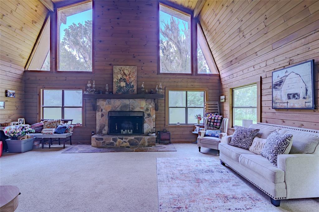 1600 Southwest 42nd Street Ocala, FL 34471 - Photo 54 of 57 a living room with furniture large window and fireplace