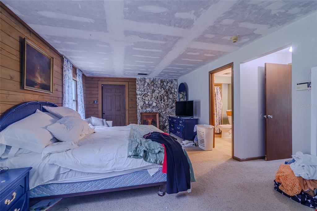 1600 Southwest 42nd Street Ocala, FL 34471 - Photo 8 of 57 a bedroom with a bed and large windows