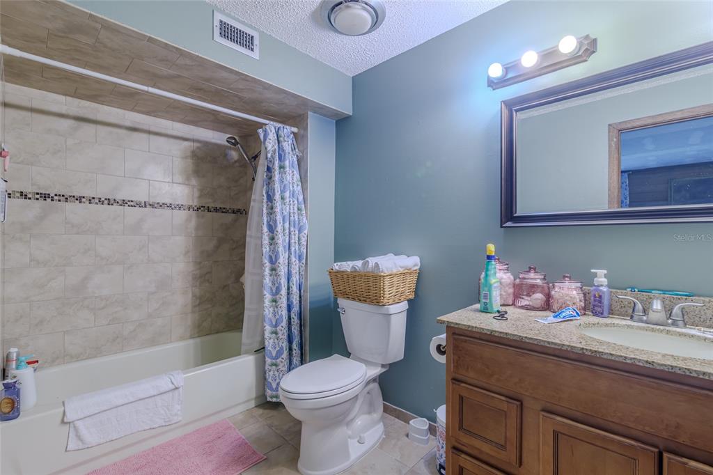 1600 Southwest 42nd Street Ocala, FL 34471 - Photo 9 of 57 a bathroom with a sink a toilet and shower