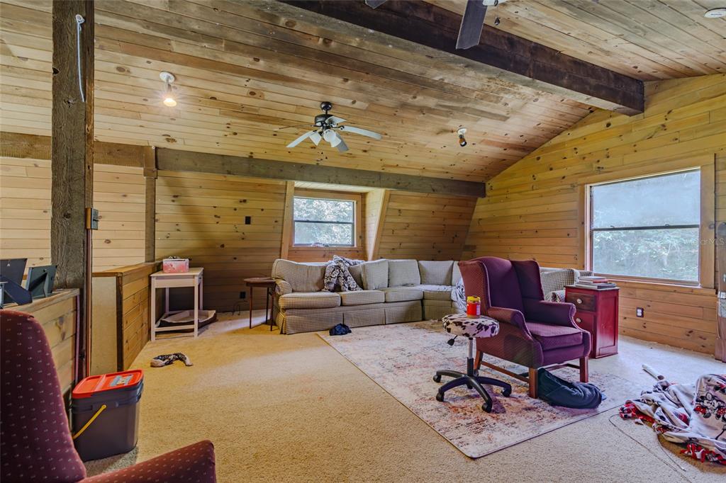 1600 Southwest 42nd Street Ocala, FL 34471 - Photo 10 of 57 a living room with furniture a flat screen tv and a large window