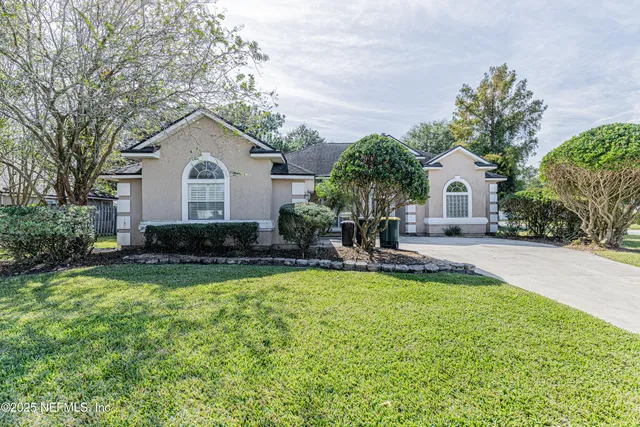 a front view of house with yard and green space