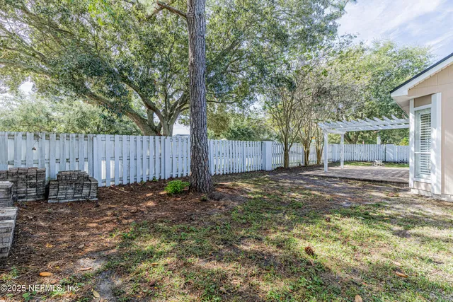 a backyard of a house with table and chairs