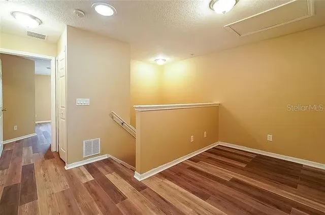a view of a room with wooden floor and staircase