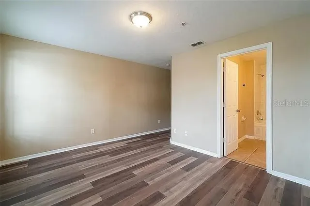 a view of room with wooden floor