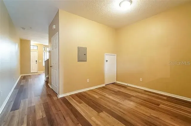 a view of a room with wooden floor