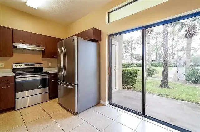 a metallic refrigerator freezer sitting in a kitchen