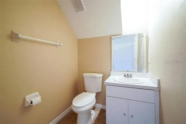 a bathroom with a sink mirror and toilet