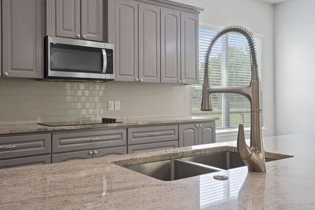 a kitchen with a sink and a microwave