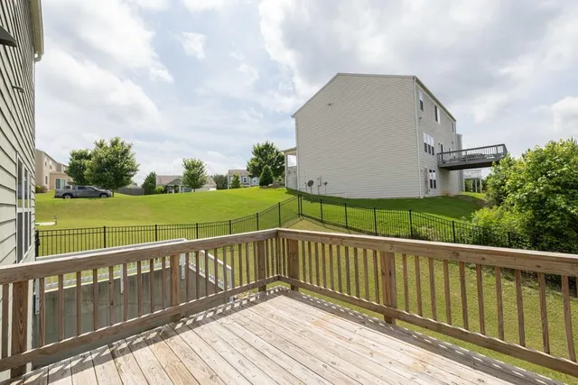 a view of a wooden deck with a yard